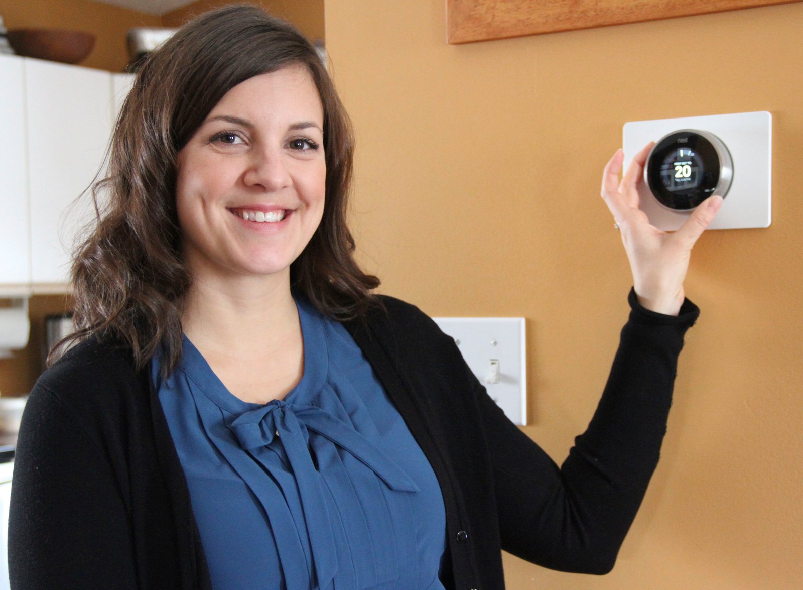 Pam Goertzen of Climate Change Central shows off the Nest programmable thermostat.