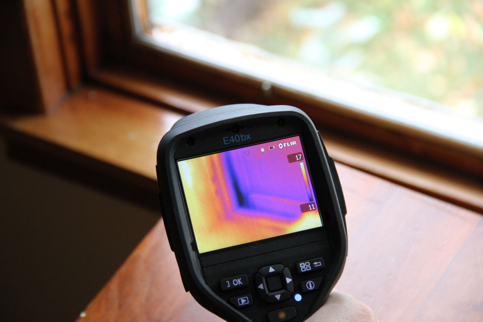 In a home audit by CReturns in Edmonton, Alberta an infared camera reveals heat leakage around the windows. The complete blanket of insulation and high performance R8 windows cut down on heat loss dramatically in new super insulated net-zero homes. Photo David Dodge, GreenEnergyFutures.ca