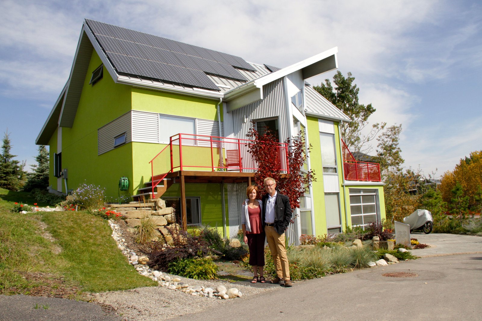 Dave Spencer and Debbie Wiltshire in front of their net-zero home. They wanted to develop a green community in Calgary and started the process more than 12 years ago. The concept turns traditional suburban neighbourhoods on its ear. Photo David Dodge, Green Energy Futures