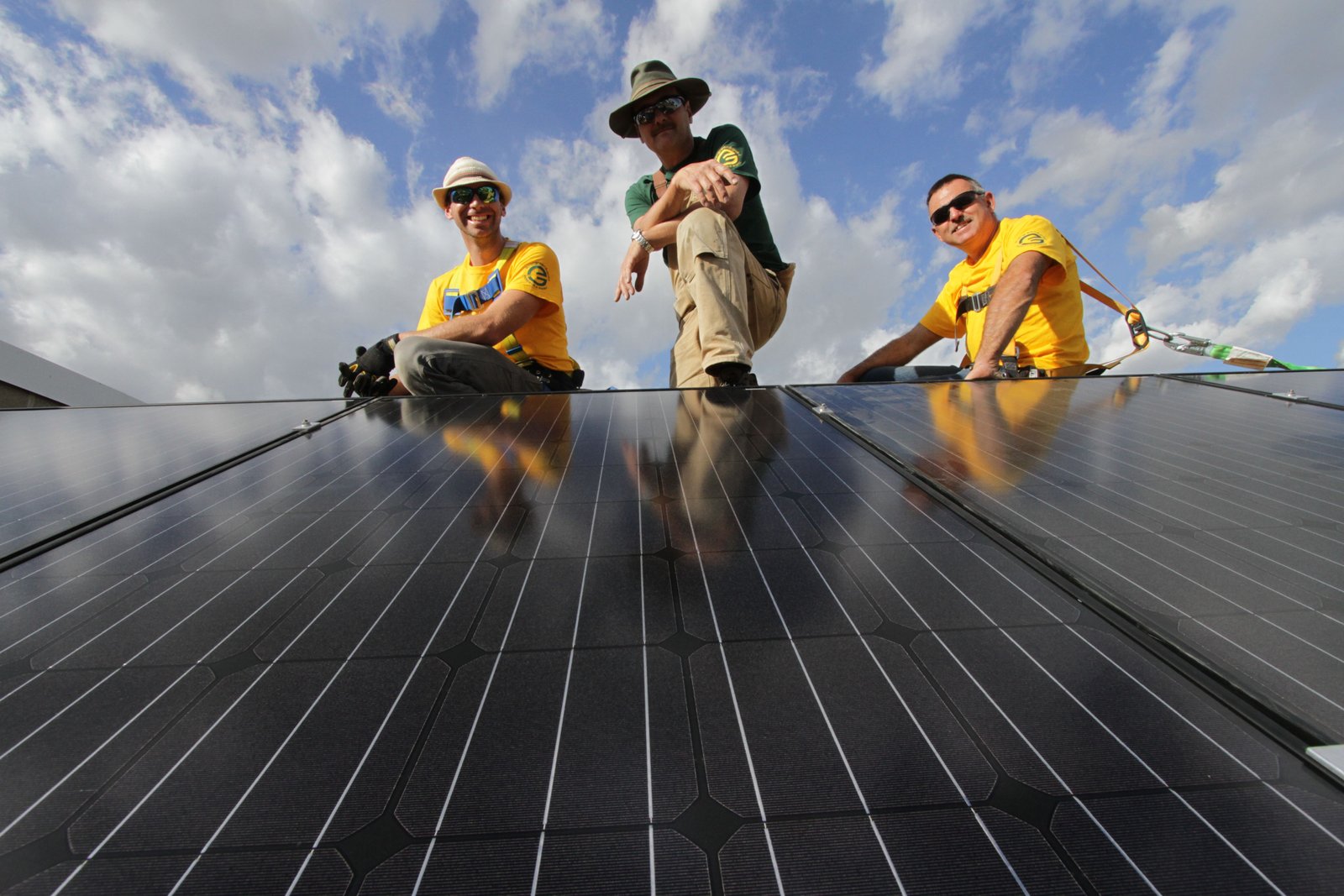 The solar crew of Dave Simmonds, Warren Sarauer and Steve Milne from Evergreen and Gold Renewable Energy pose with Evansdale Community League's new 13.6 kilowatt solar system that will provide half of the community organizations electricity over the course of a year. Photo David Dodge, GreenEnergyFutures.ca