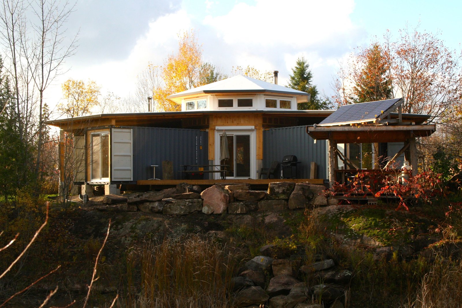 Jason Rioux's shipping container cabin. The cabin was built out of seven sea containers in a hub and spoke pattern near Bobcaygeon, Ontario. This incredibly innovative sea container cabin is powered by a small 1 kW solar system and is packed with energy efficiency innovation - probably part of the reason the video has more than 100k views on YouTube. Photo Courtesy of Jason Rioux