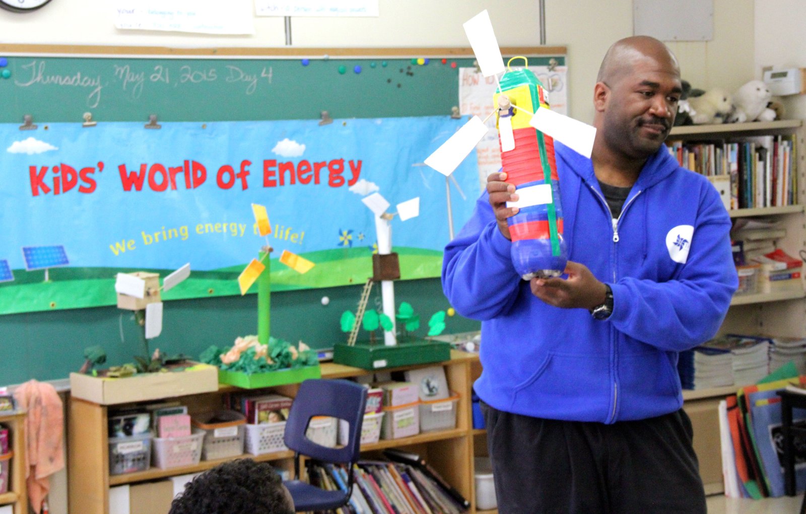 Abasi Sanders shows off one of the creatively designed wind turbines created by students involved in the TREC Education Capture the Wind program in a Toronto school. Photo David Dodge, GreenEnergyFutures.ca