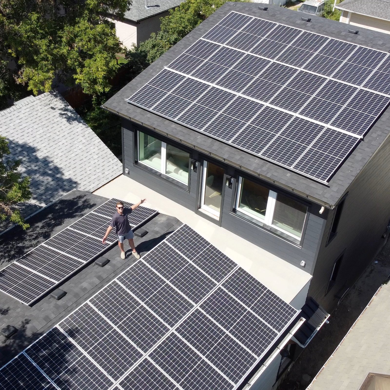 Axel Sorensen on roof with sea of solar