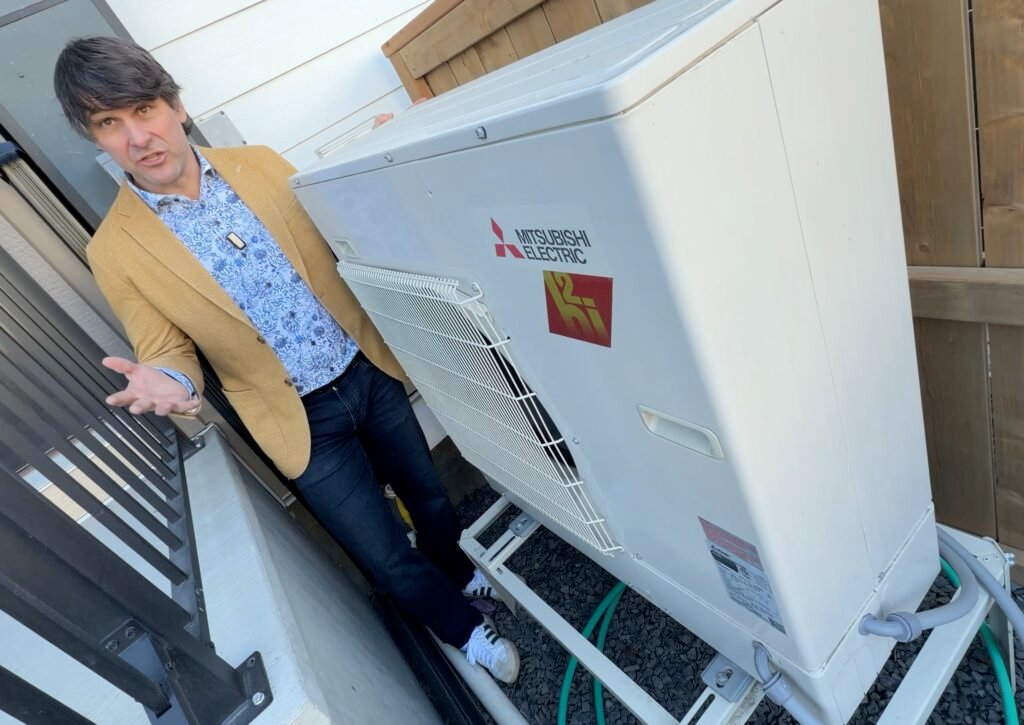 Chris Williams with heat pump exterior1 angle
